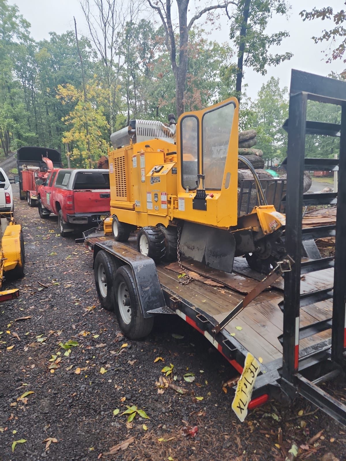 A yellow machine is sitting on top of a trailer.