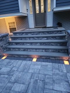 A set of stairs leading up to the front door of a house.