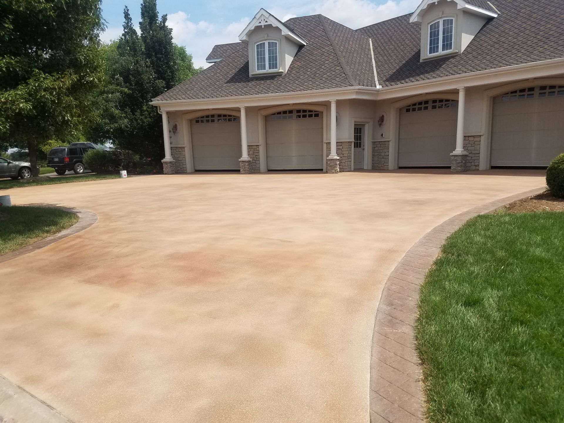 A large house with a concrete driveway in front of it