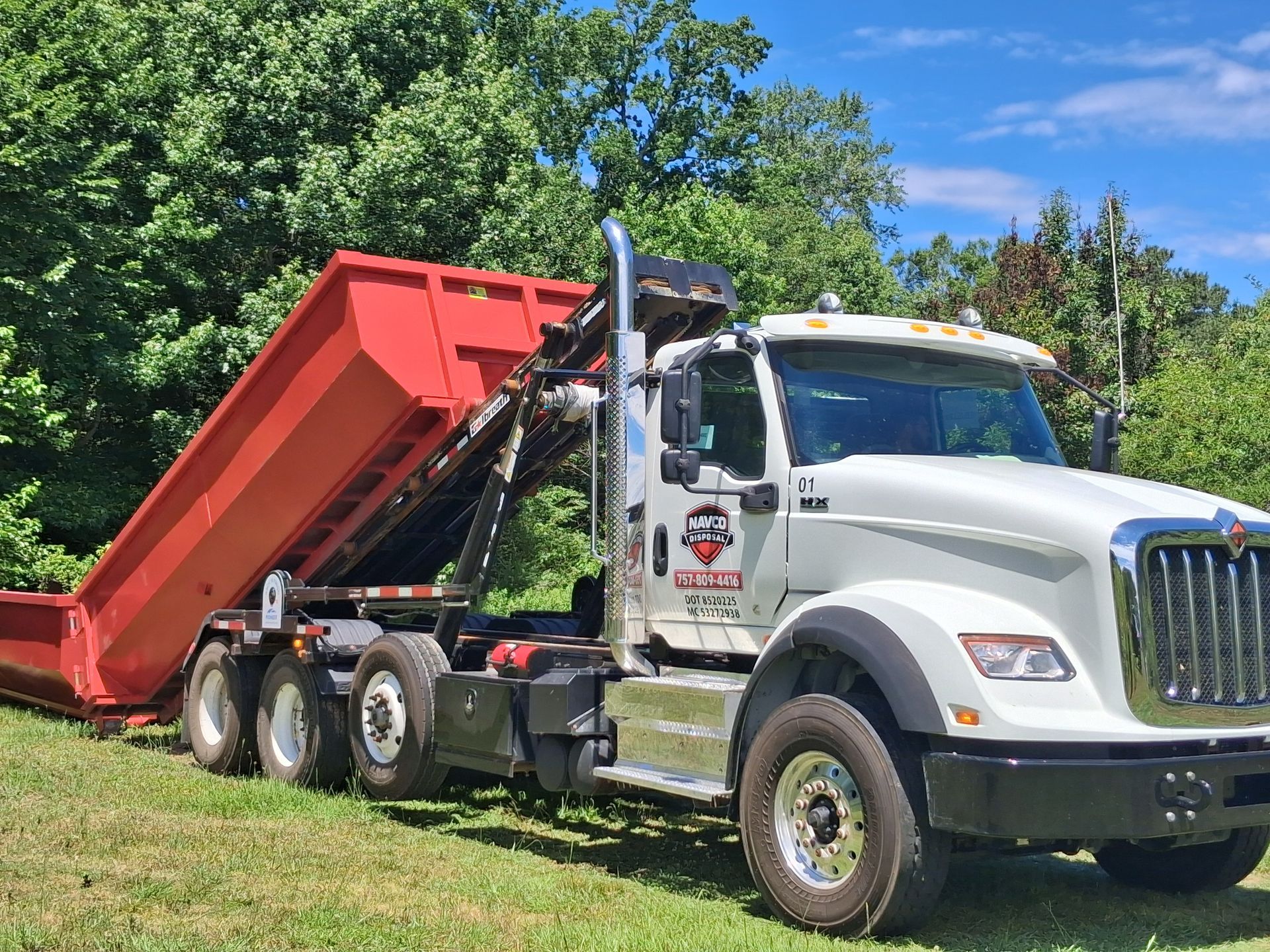 truck with roll off dumpster 