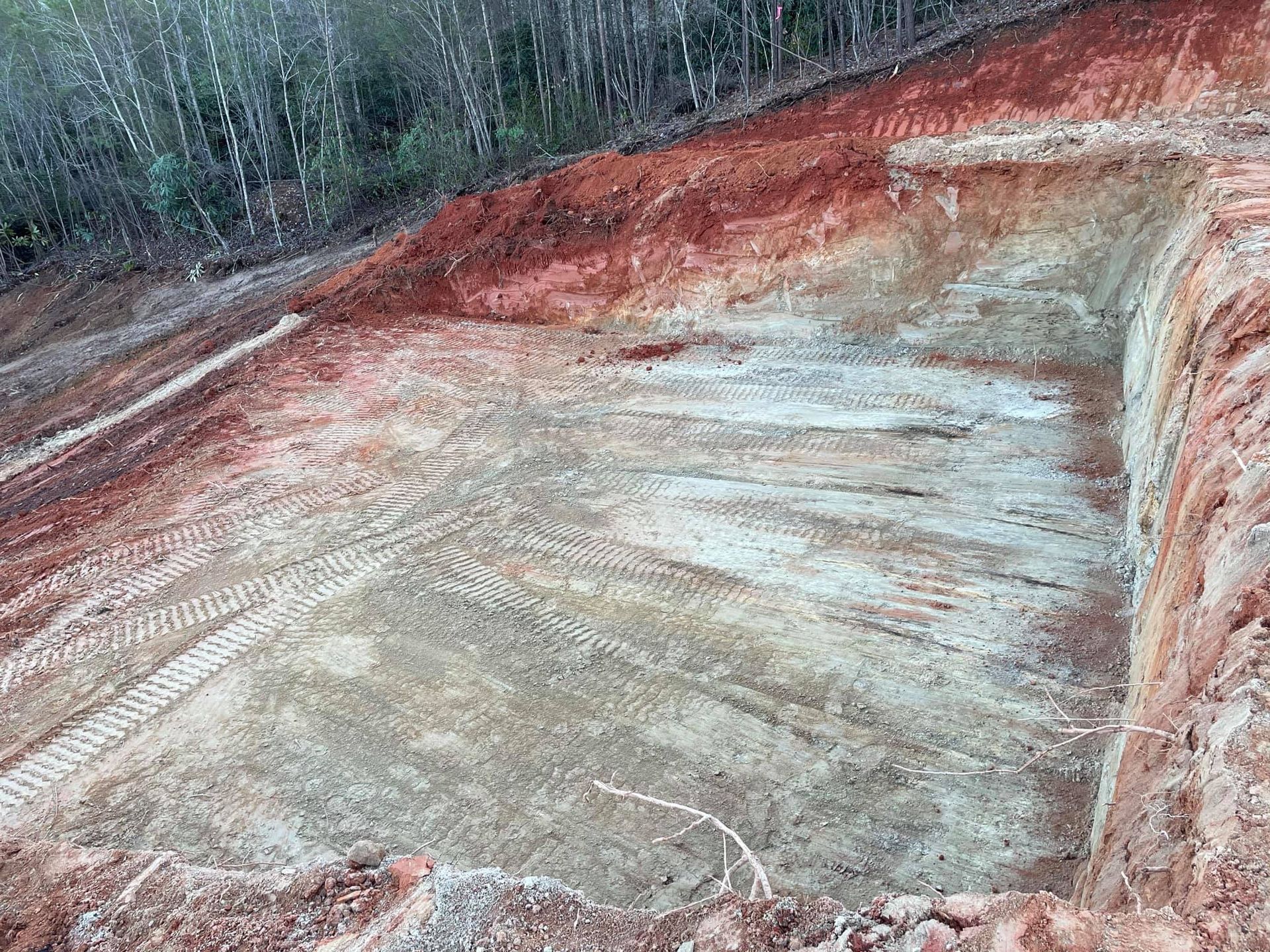 A large pile of dirt is sitting on top of a dirt hill.