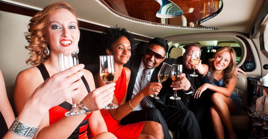 A group of people are sitting in a limousine toasting with champagne glasses.