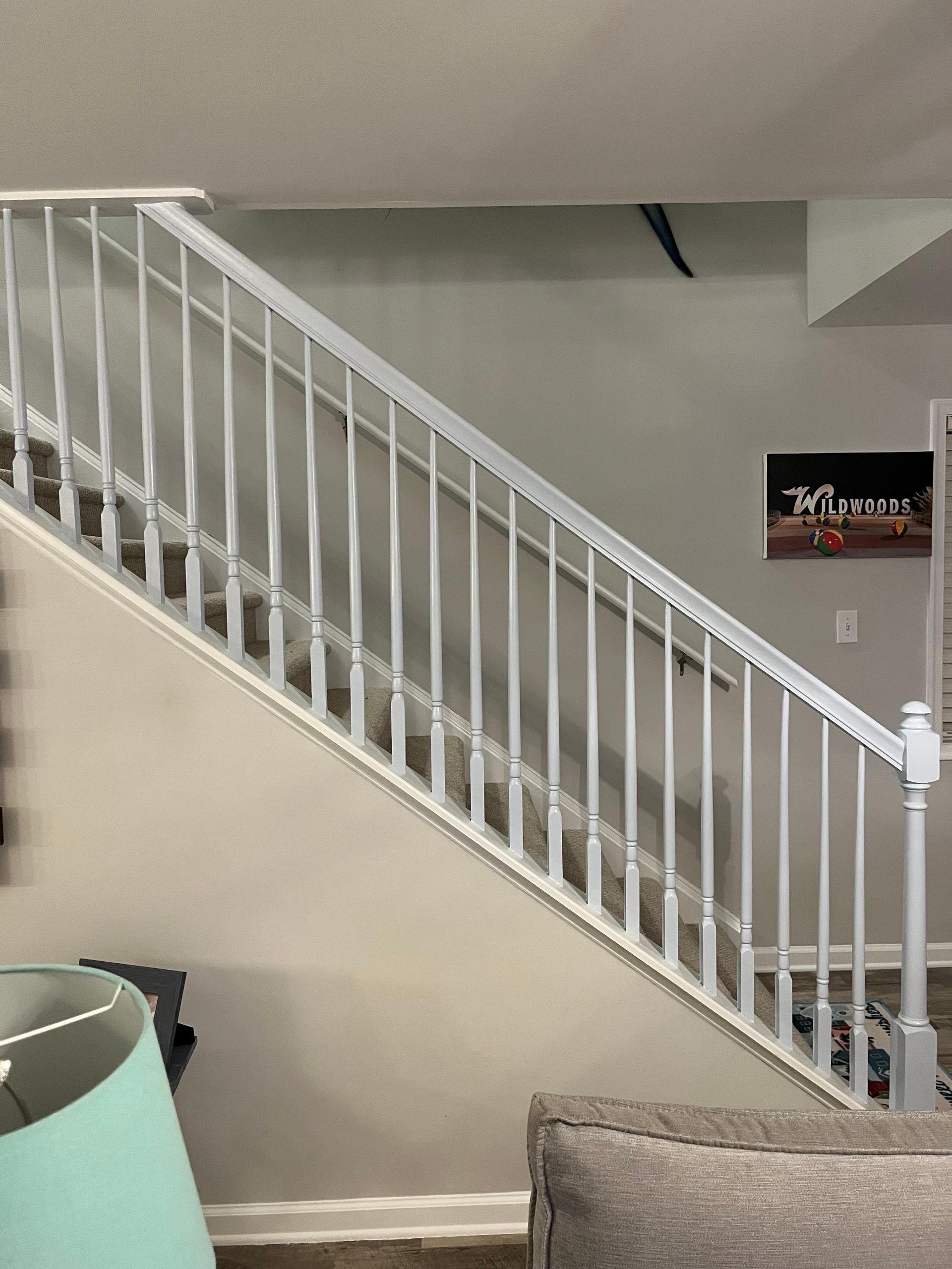 A living room with stairs leading up to the second floor.