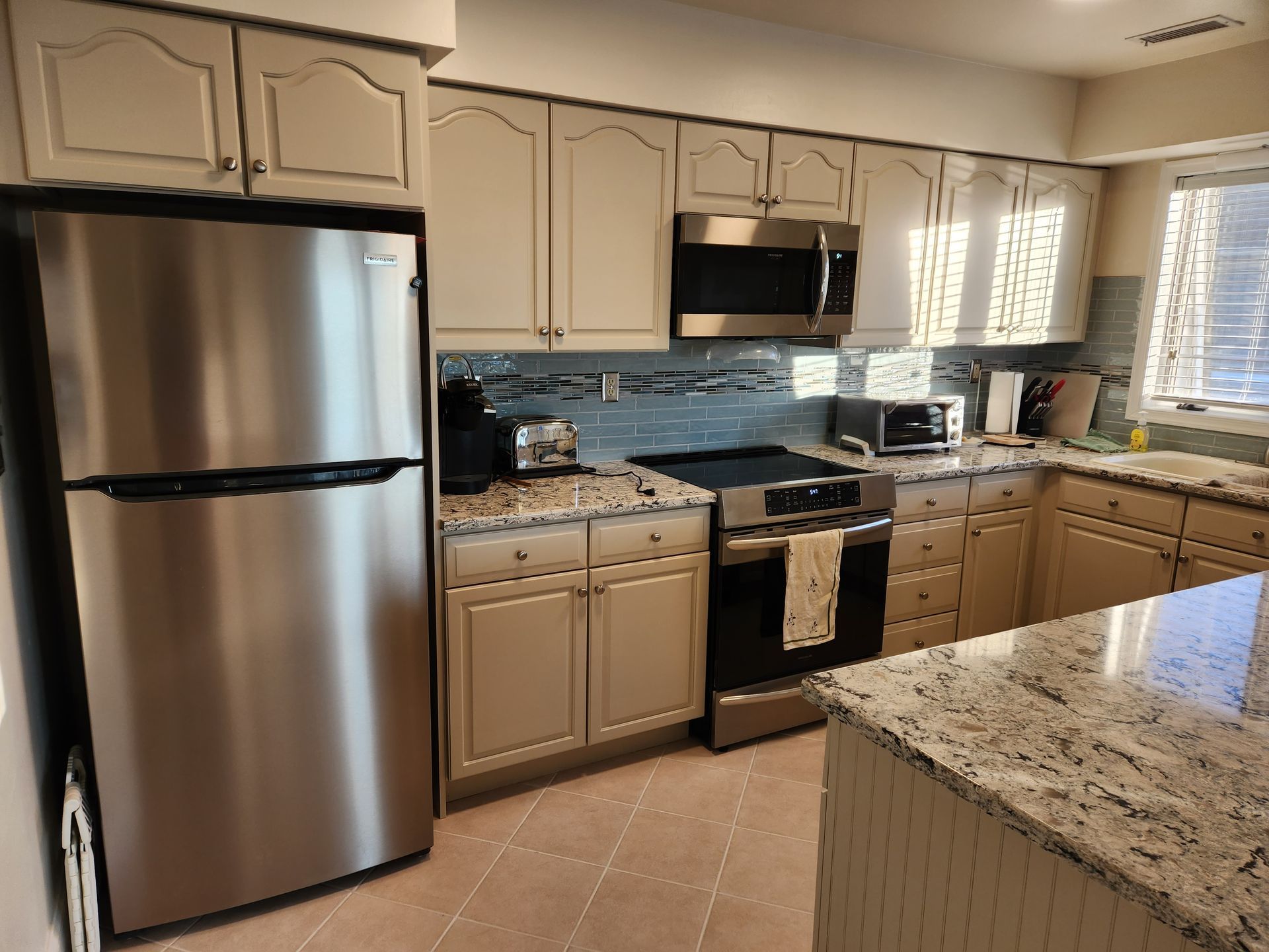 A kitchen with stainless steel appliances and granite counter tops