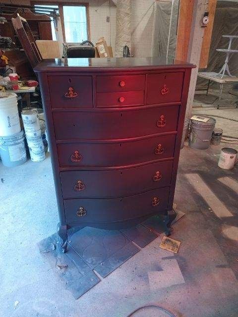 A chest of drawers is sitting on the floor in a room.