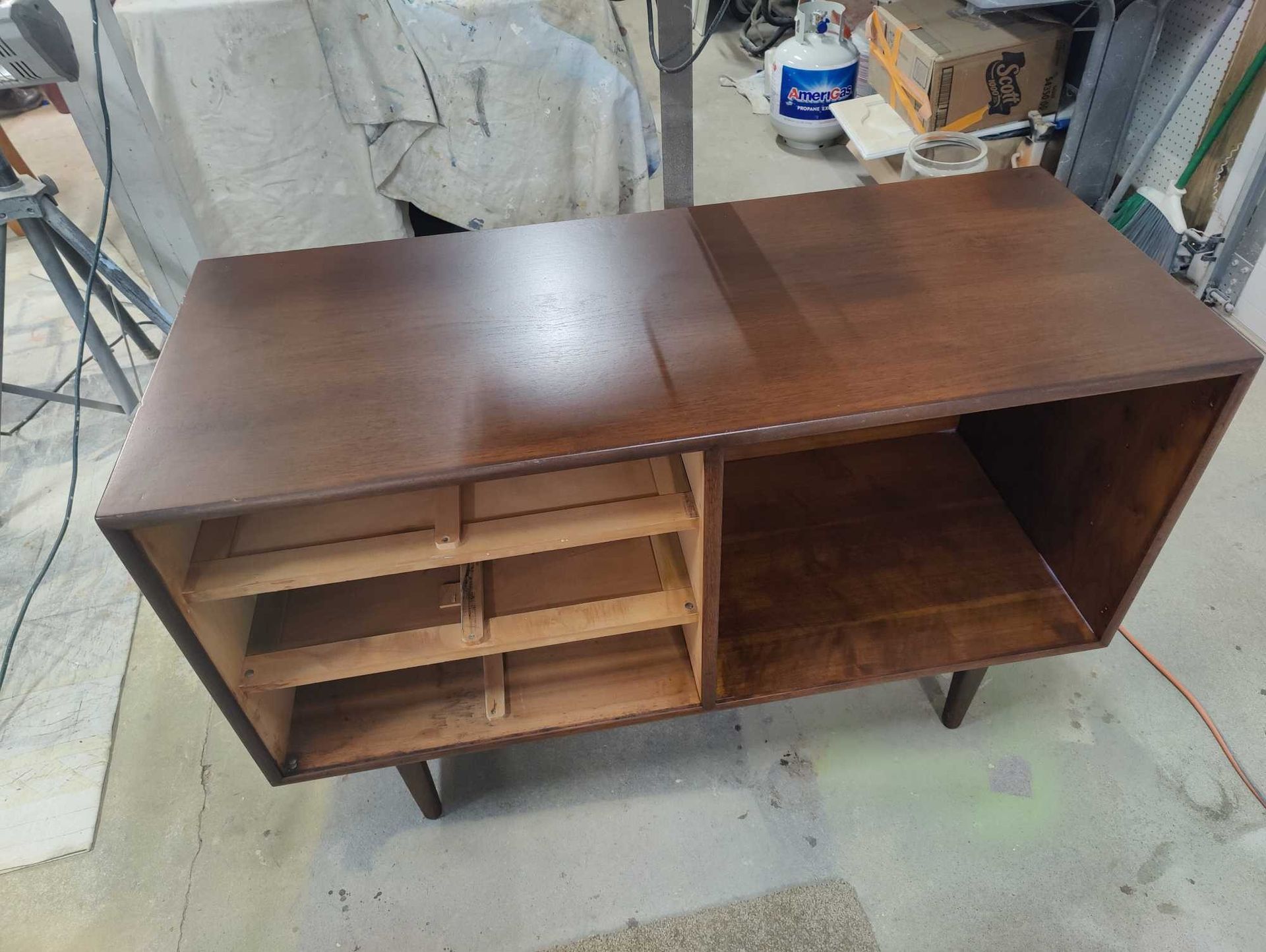 A wooden table with drawers is sitting on the floor in a room.