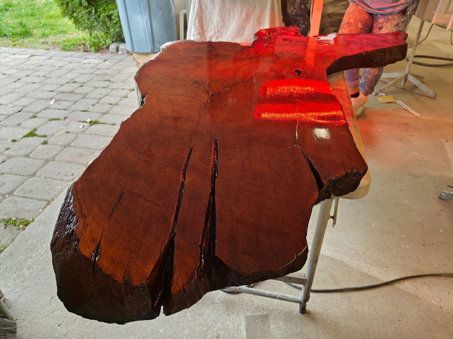 A large piece of wood is sitting on a table outside