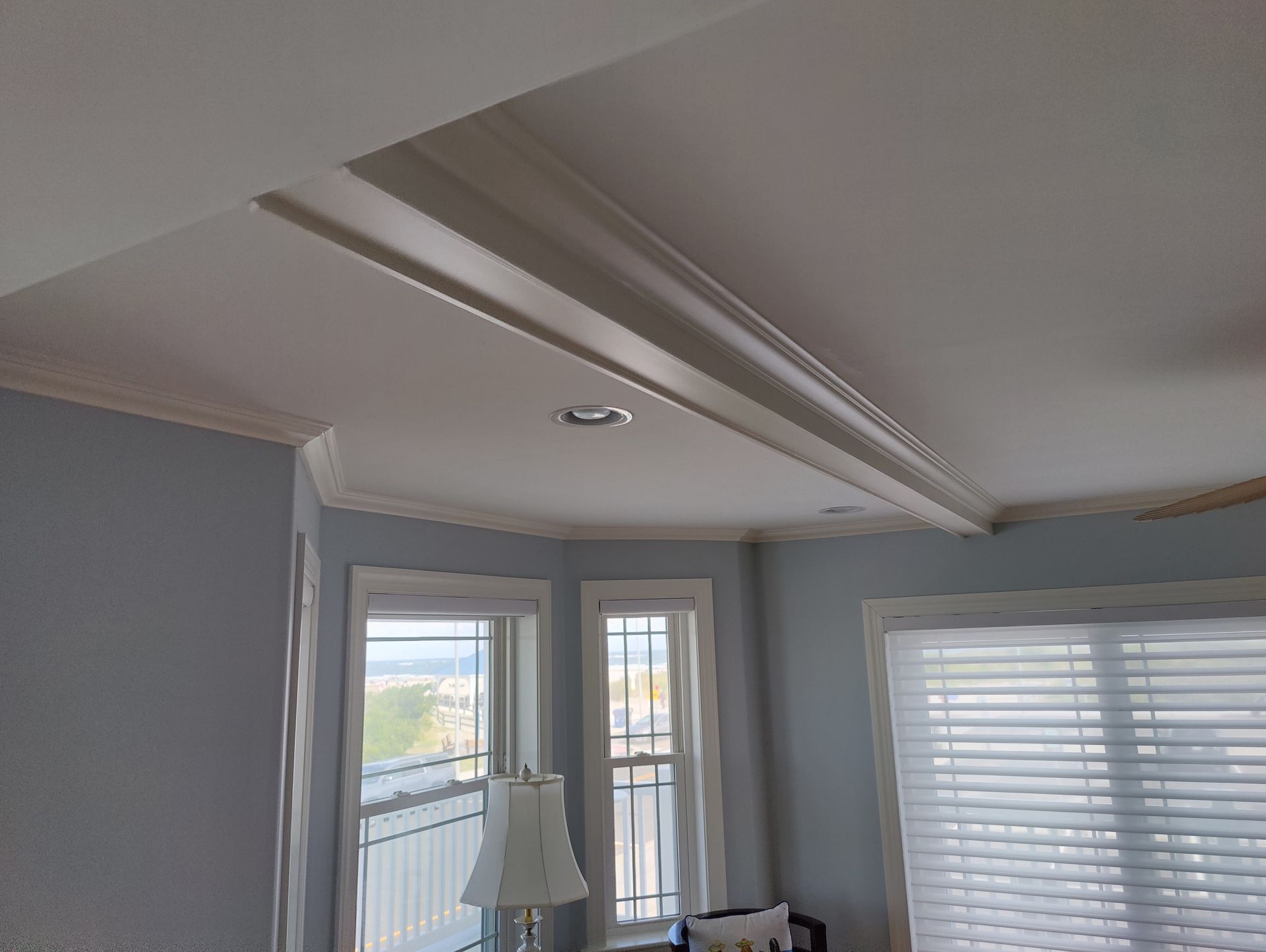 A living room with a lot of windows and a white ceiling