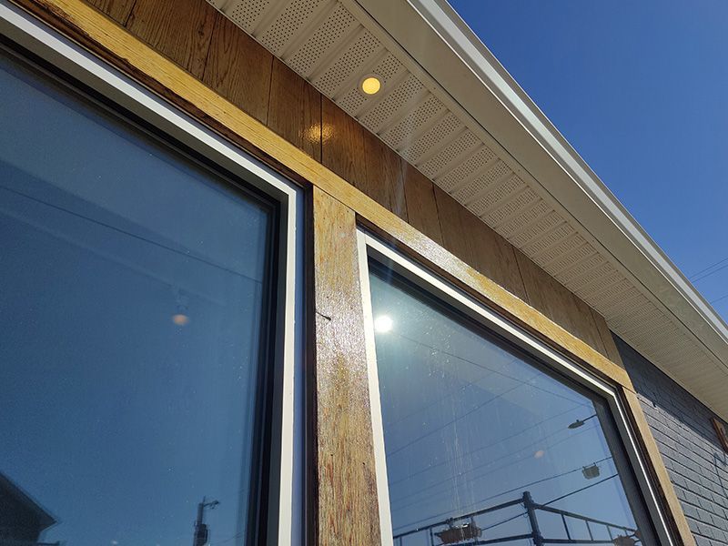 A house with a lot of windows and a blue sky in the background