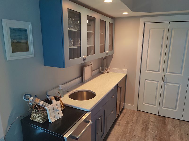 A kitchen with a sink , refrigerator and cabinets