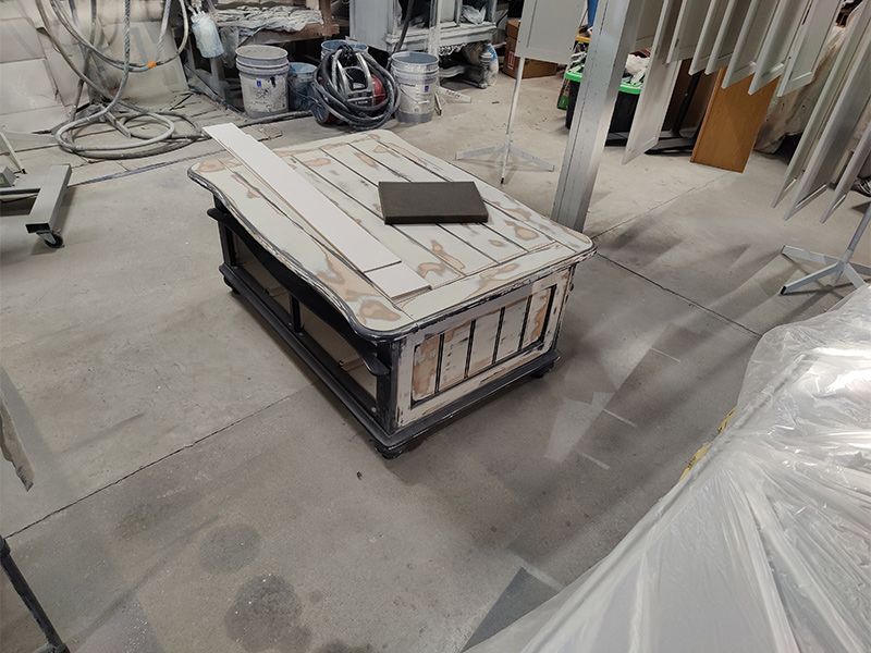 A small wooden table is sitting on the floor in a room.