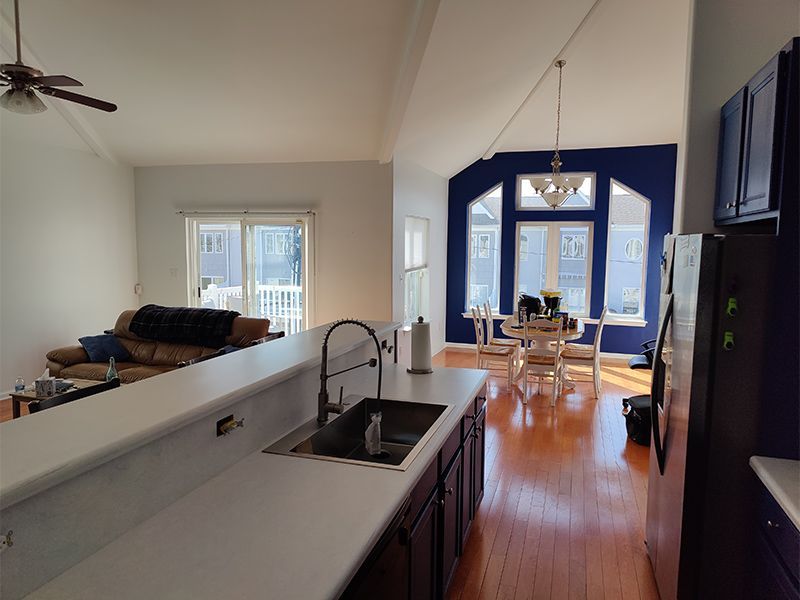 A kitchen with a sink and a ceiling fan