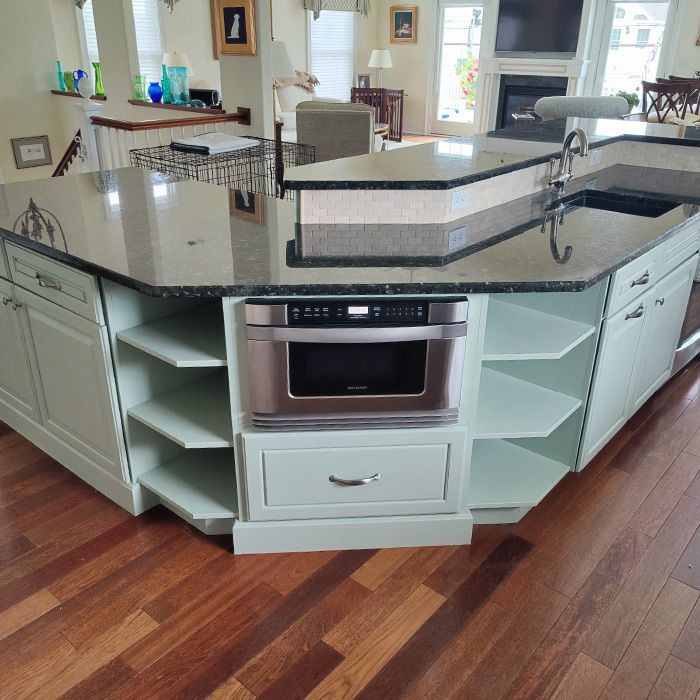 A kitchen with a microwave oven and a sink