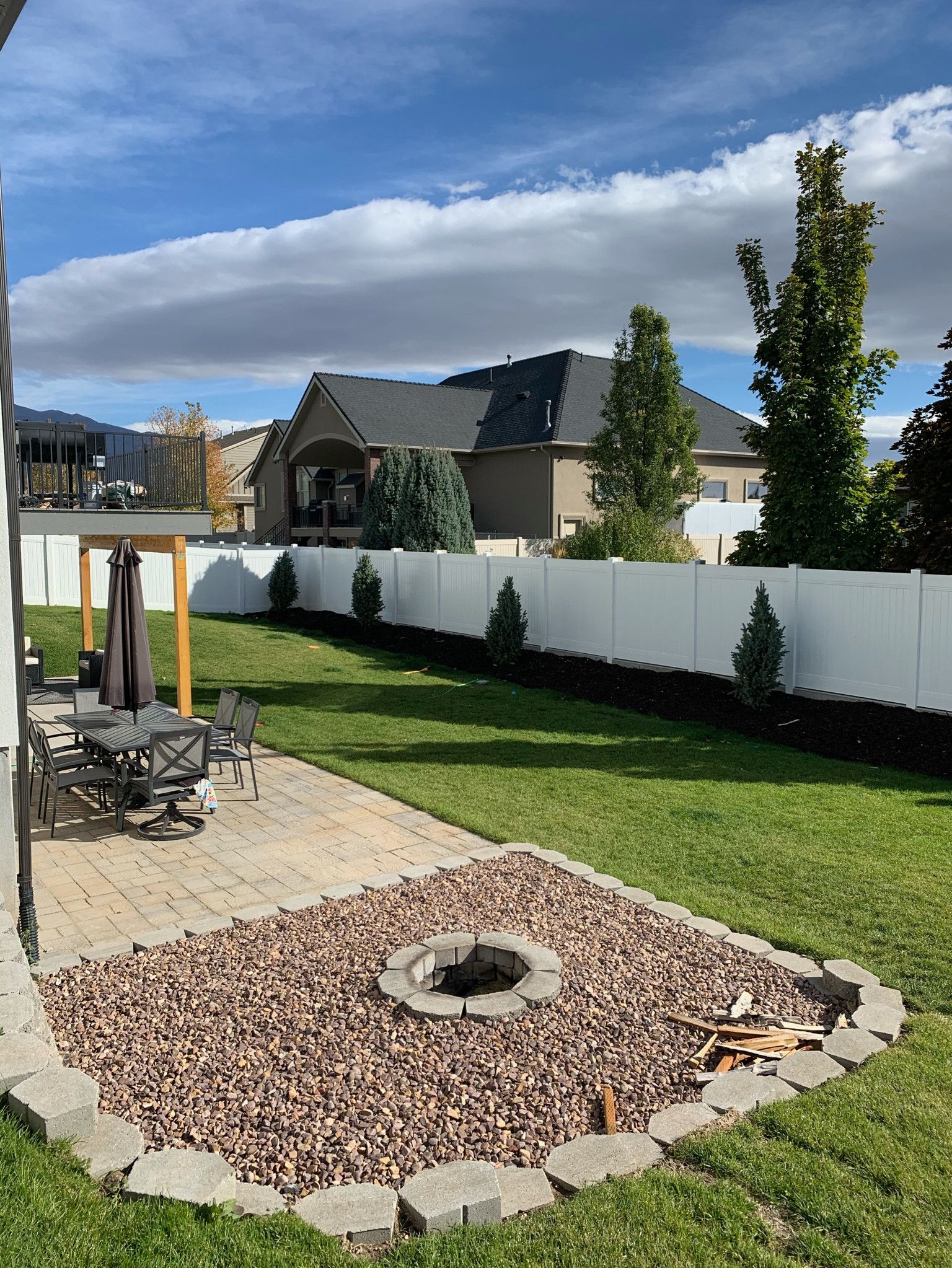 There is a fire pit in the middle of the backyard.