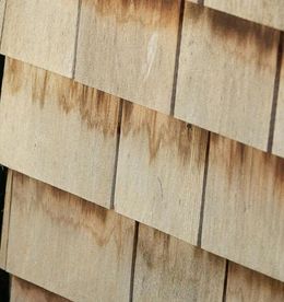 A close up of a wooden shingle roof