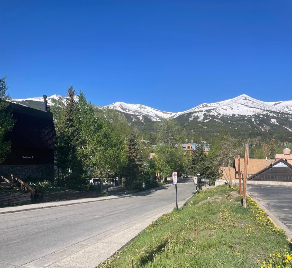 A street in a small town with mountains in the background.