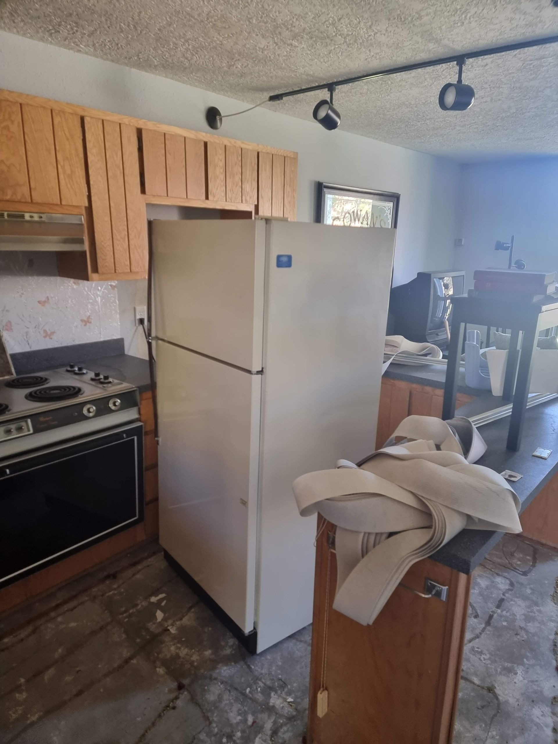 Kitchen pre-renovation with old wood cabinets 