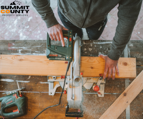 A man is using a circular saw to cut a piece of wood for a project in Avon Colorado