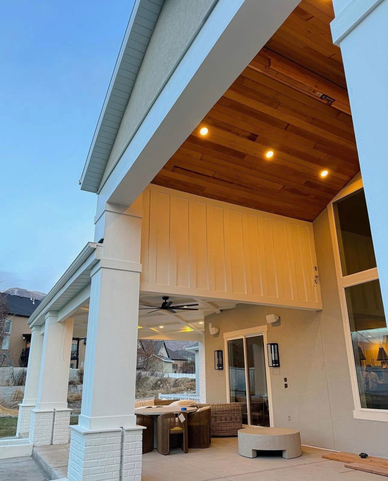 A house with a covered porch and a wooden ceiling