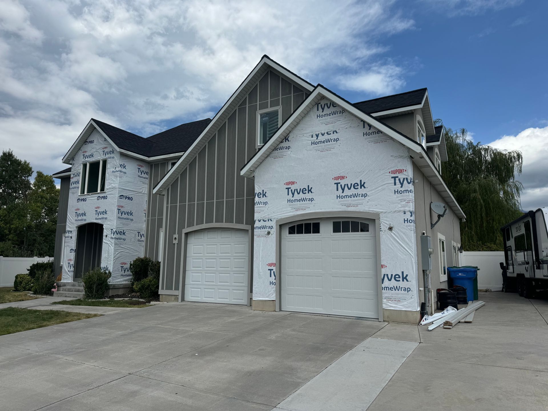 A large house with two garage doors is being built.