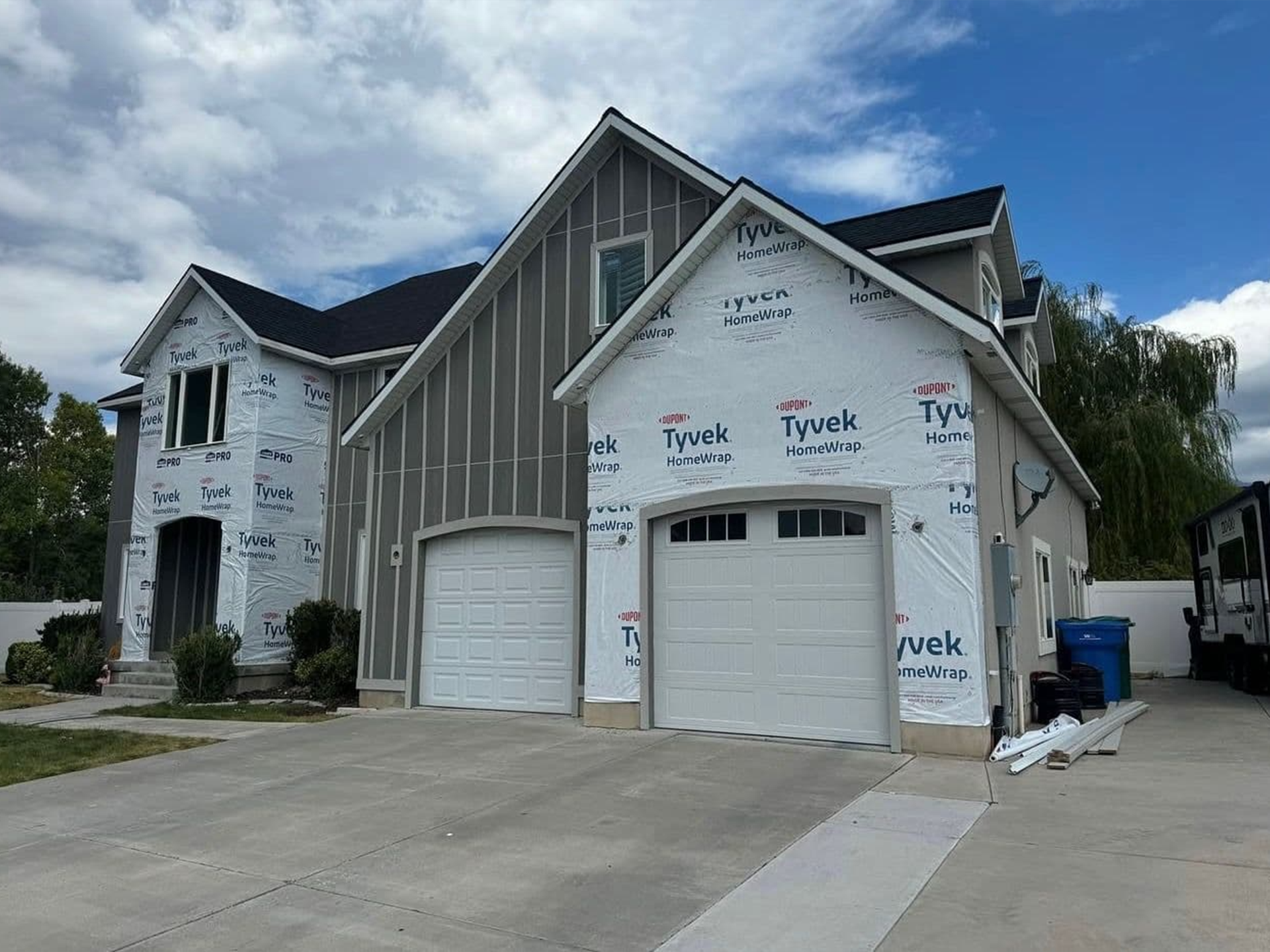 A large house with two garage doors is being built.