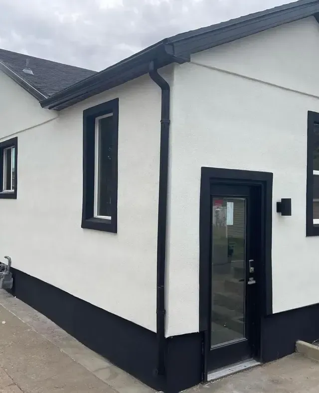 A white house with black trim and a black door