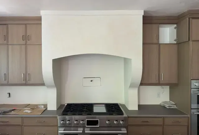 A kitchen with stainless steel appliances and wooden cabinets