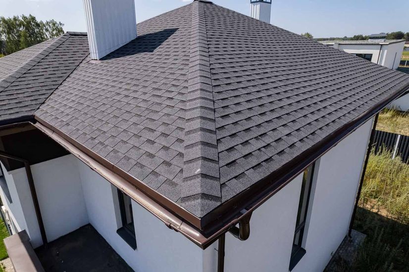 An aerial view of a house with a gray roof.
