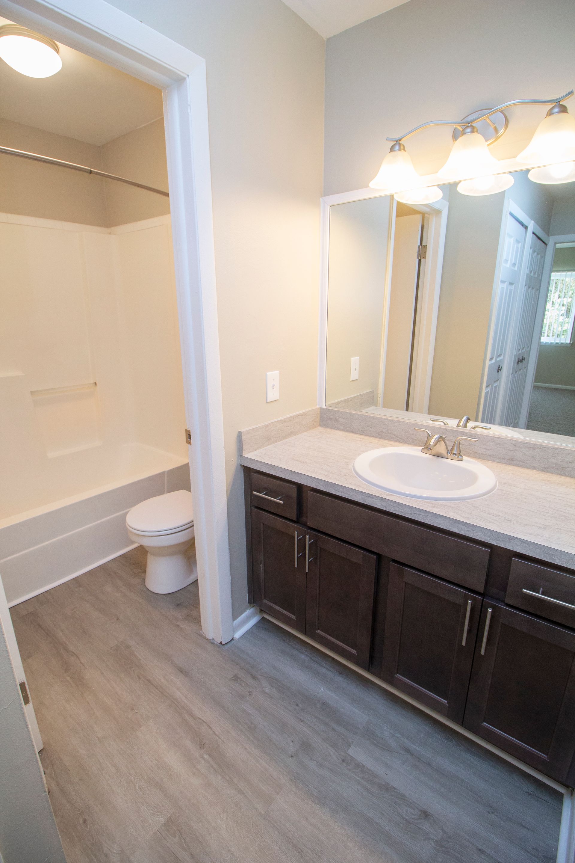 A bathroom with a sink , toilet , and mirror.