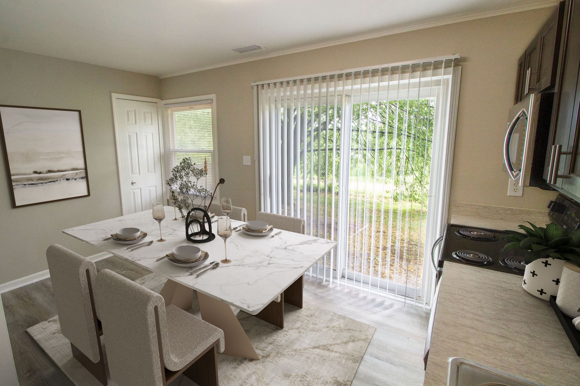 A dining room with a table and chairs and a sliding glass door.