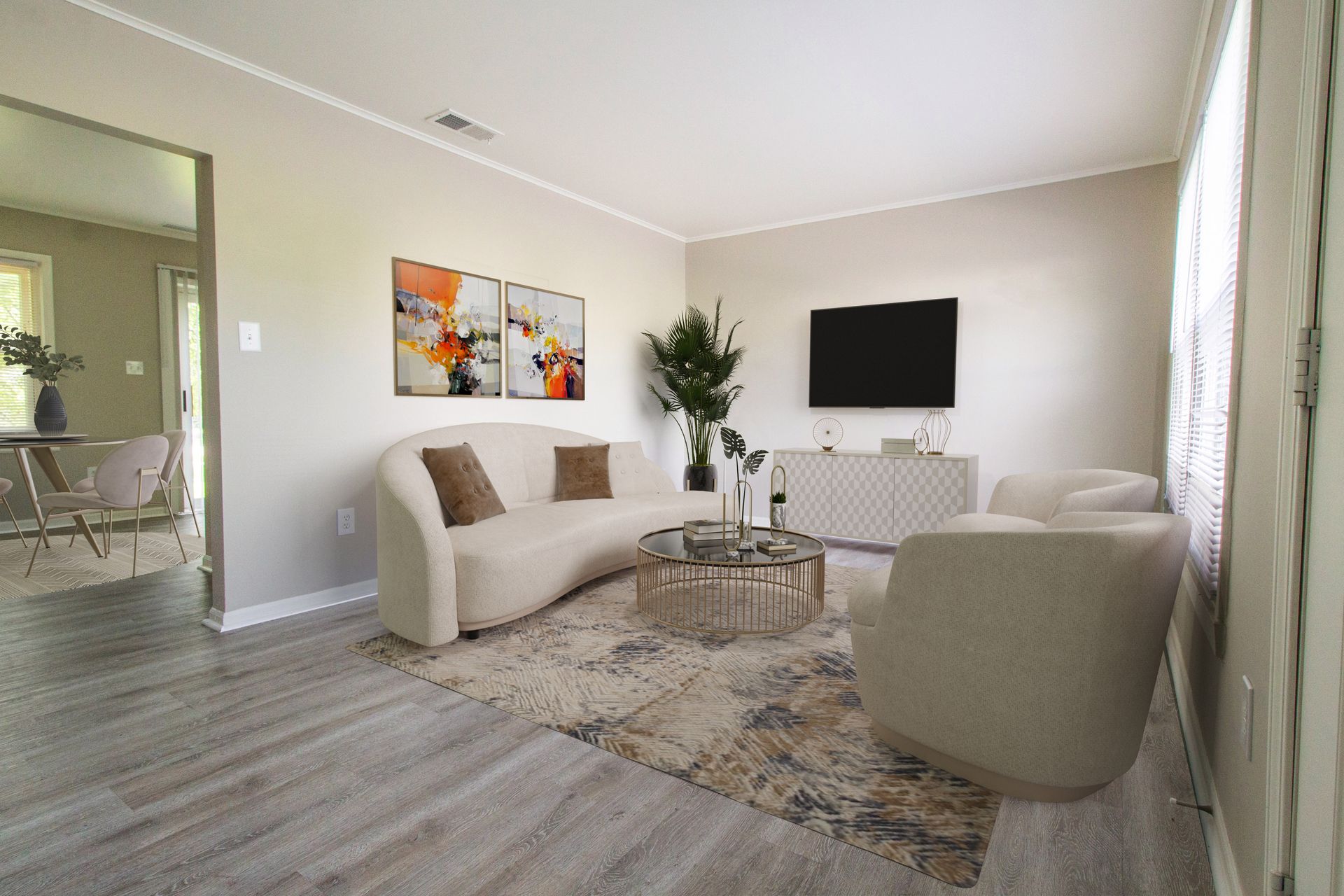 A living room with a couch , chairs , and a flat screen tv.
