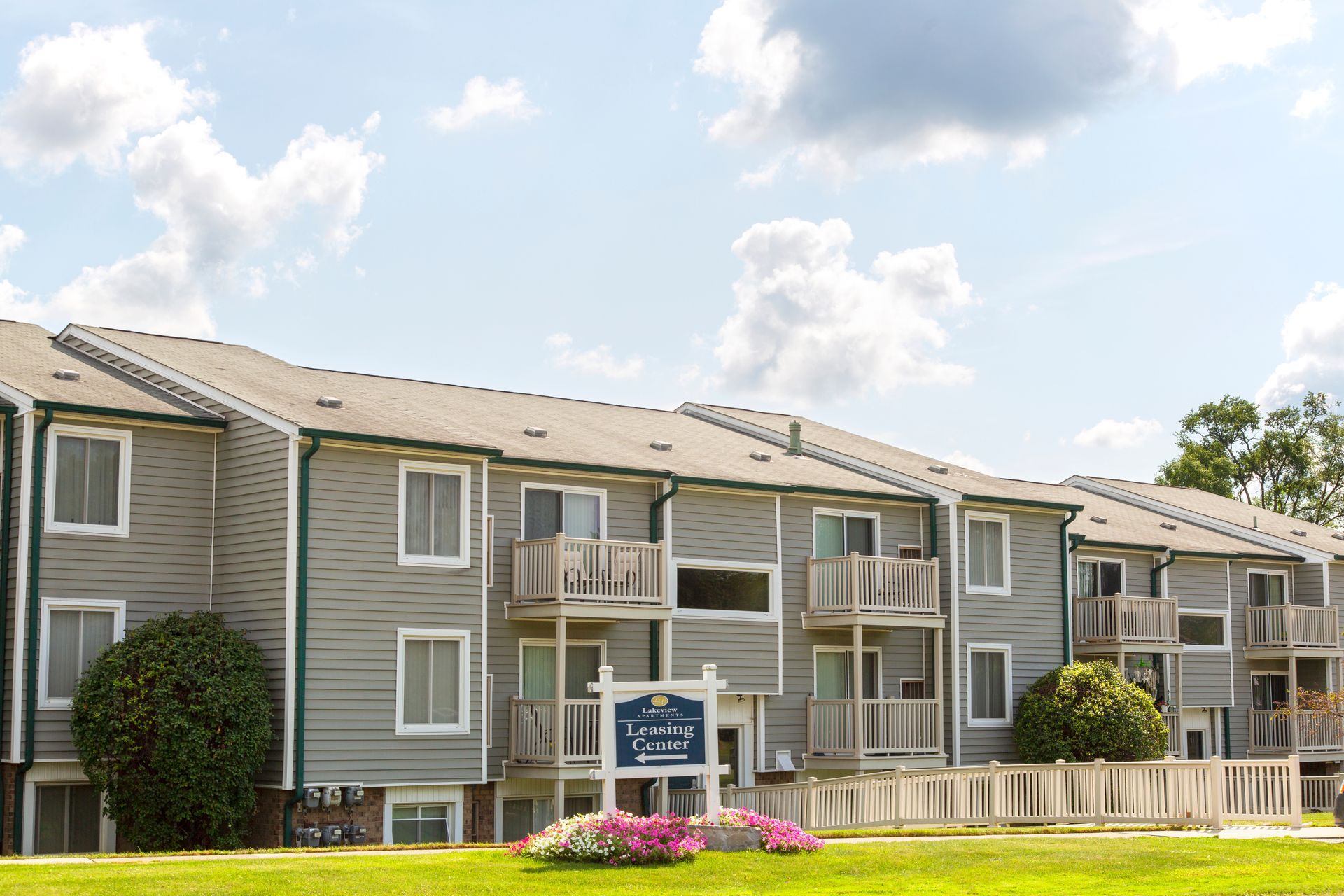 A large apartment building with a sign in front of it.
