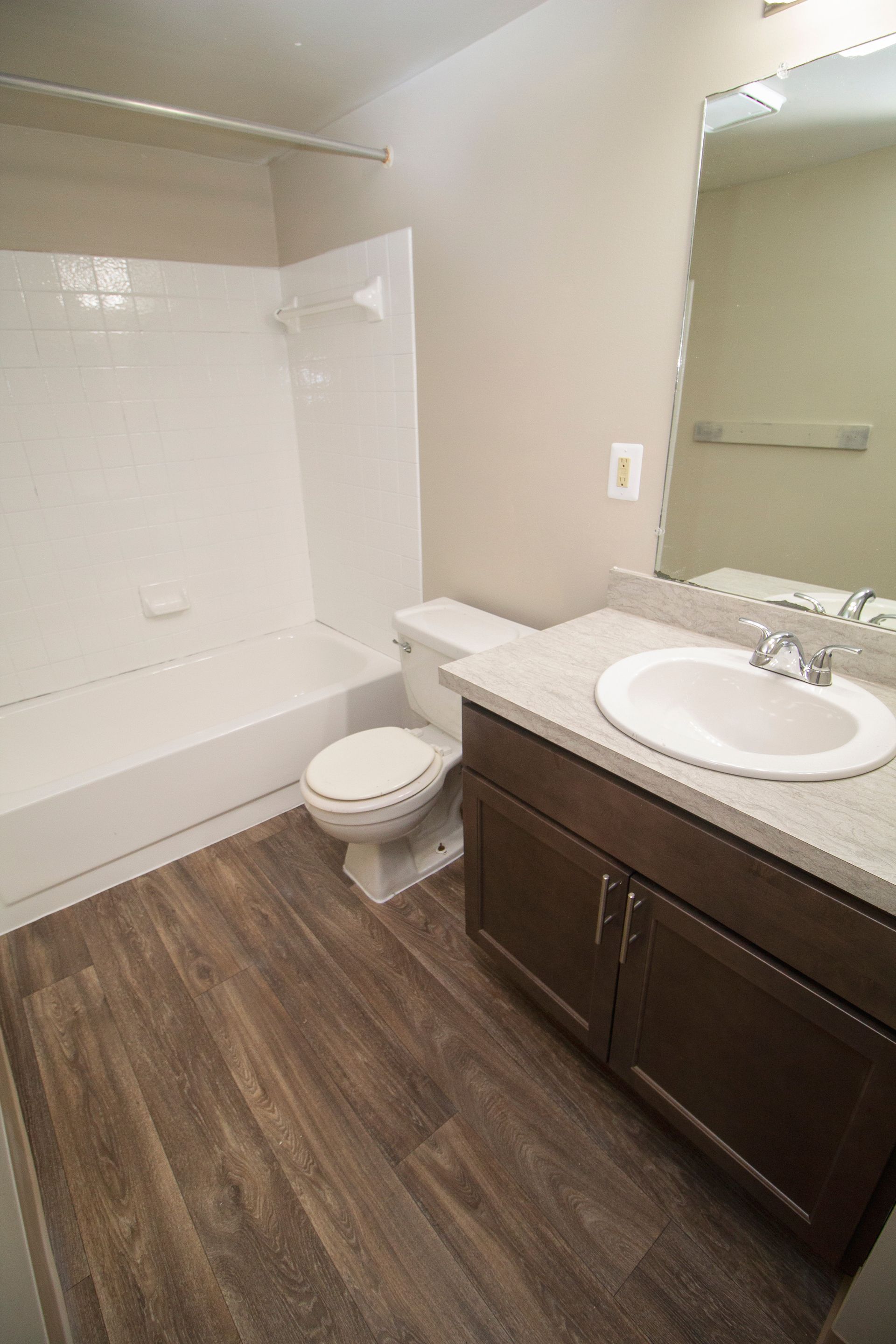 A bathroom with a toilet , sink , and bathtub.