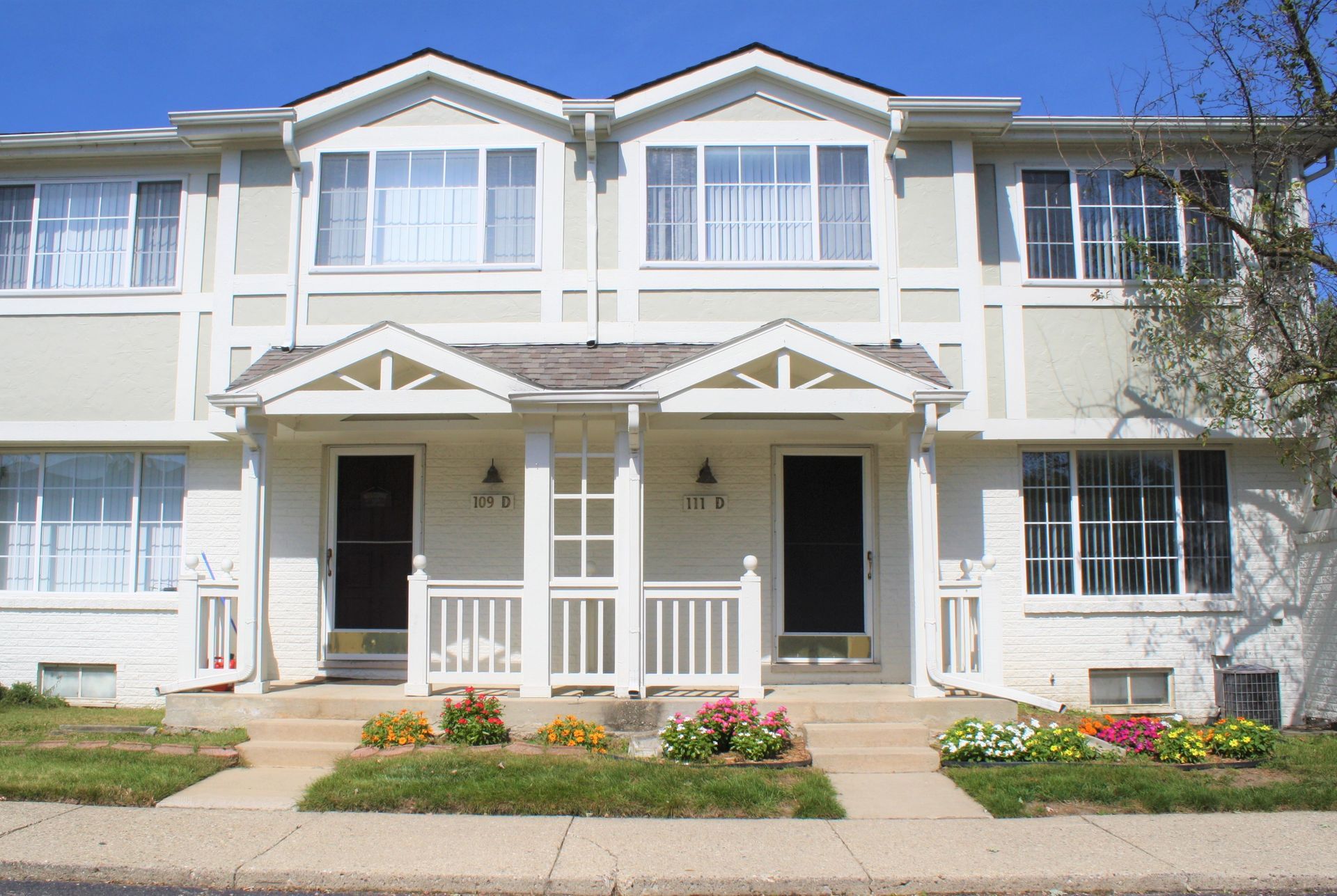 A white house with a porch and stairs