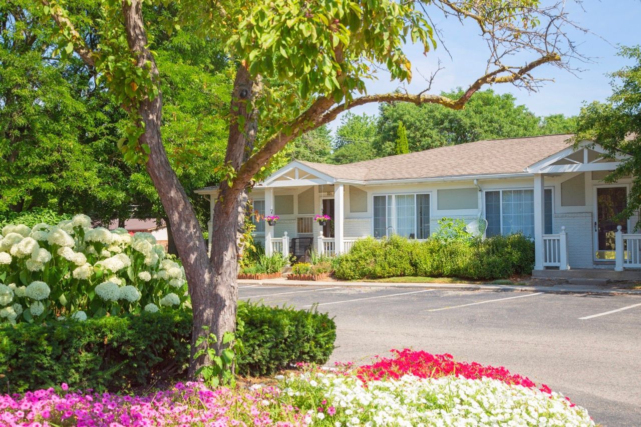 A house with a lot of flowers in front of it