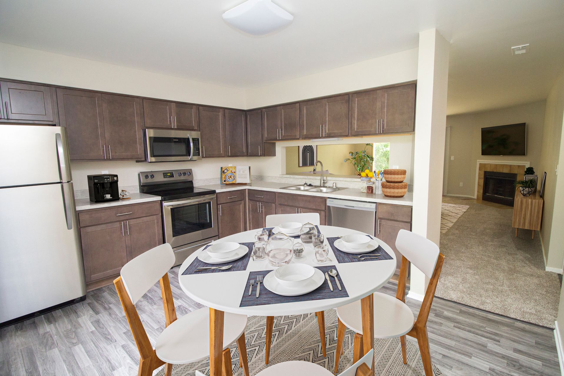 A kitchen with a round table and chairs in it