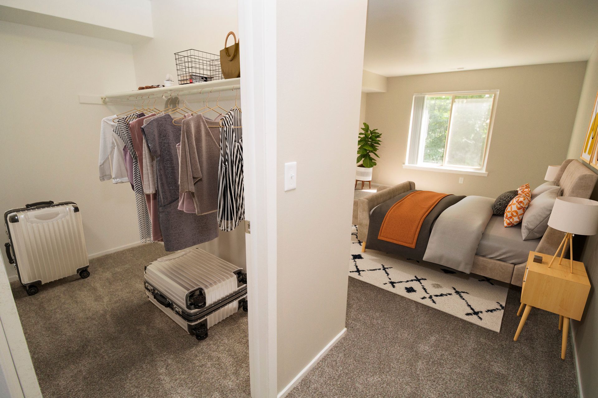 A bedroom with a walk in closet and a bed.