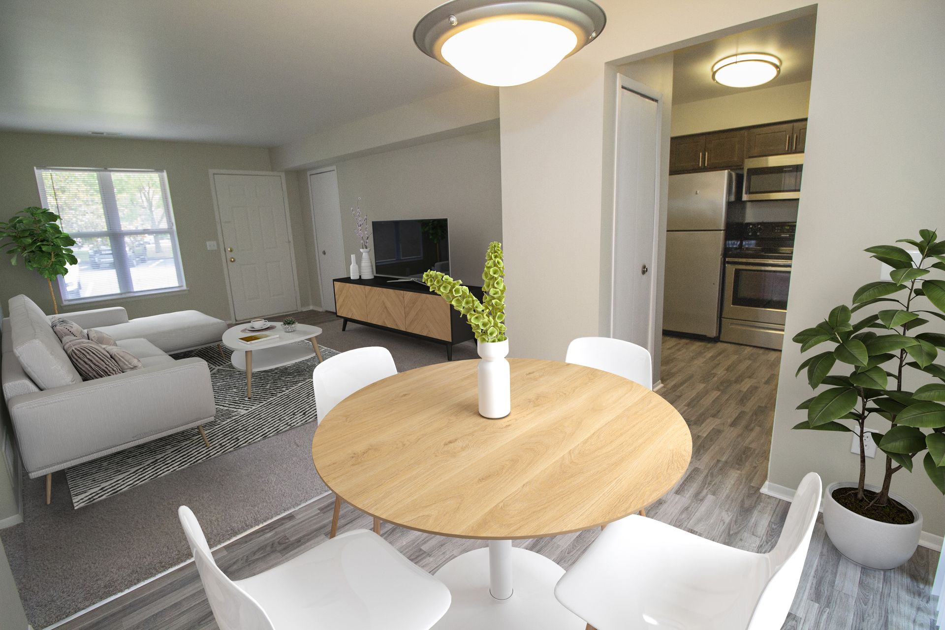 A living room with a round table and chairs in it