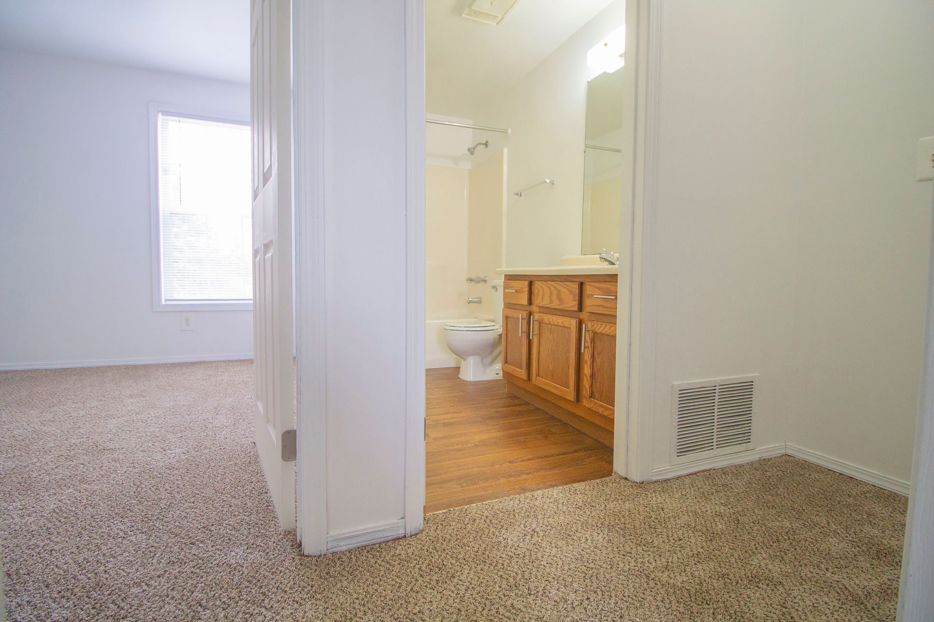 A bathroom with a toilet , sink , and bathtub in a house.