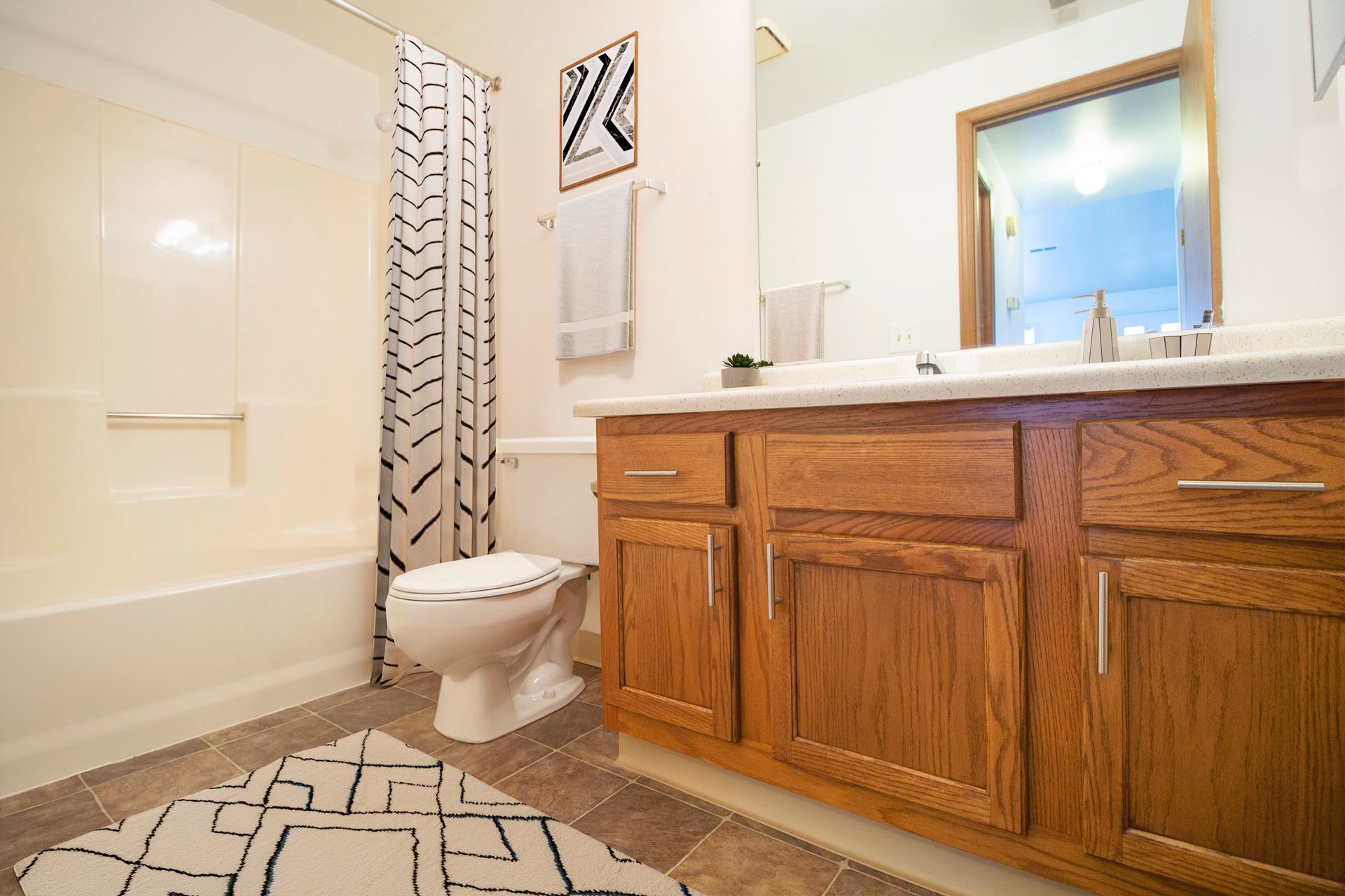 A bathroom with a toilet , sink , and bathtub.