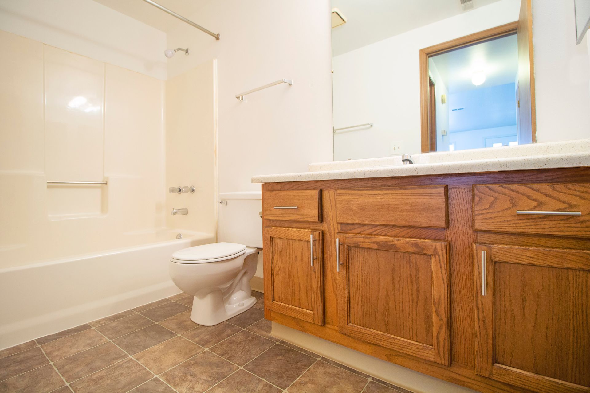A bathroom with a toilet , sink , and bathtub.