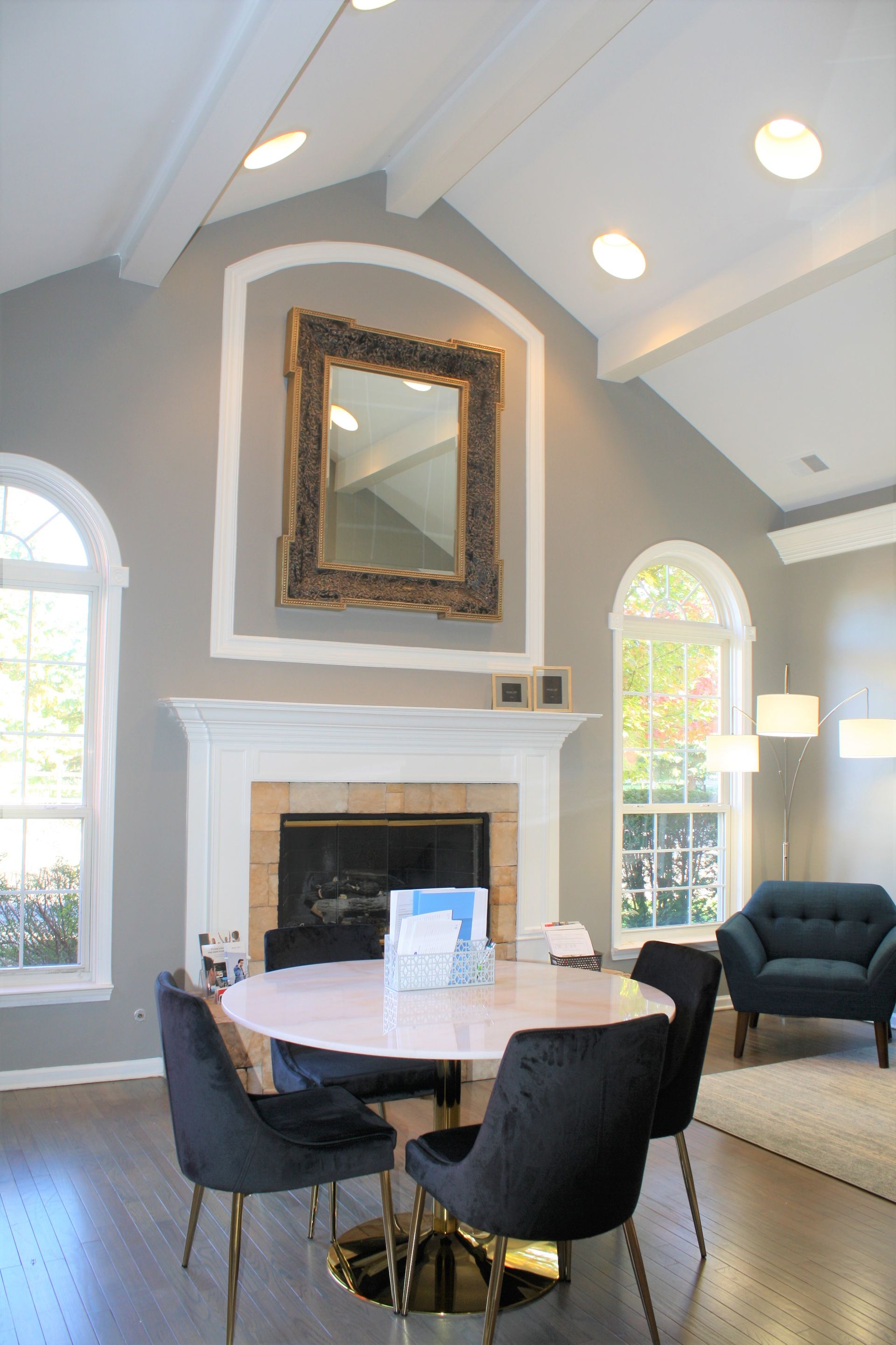 A living room with a table and chairs and a fireplace