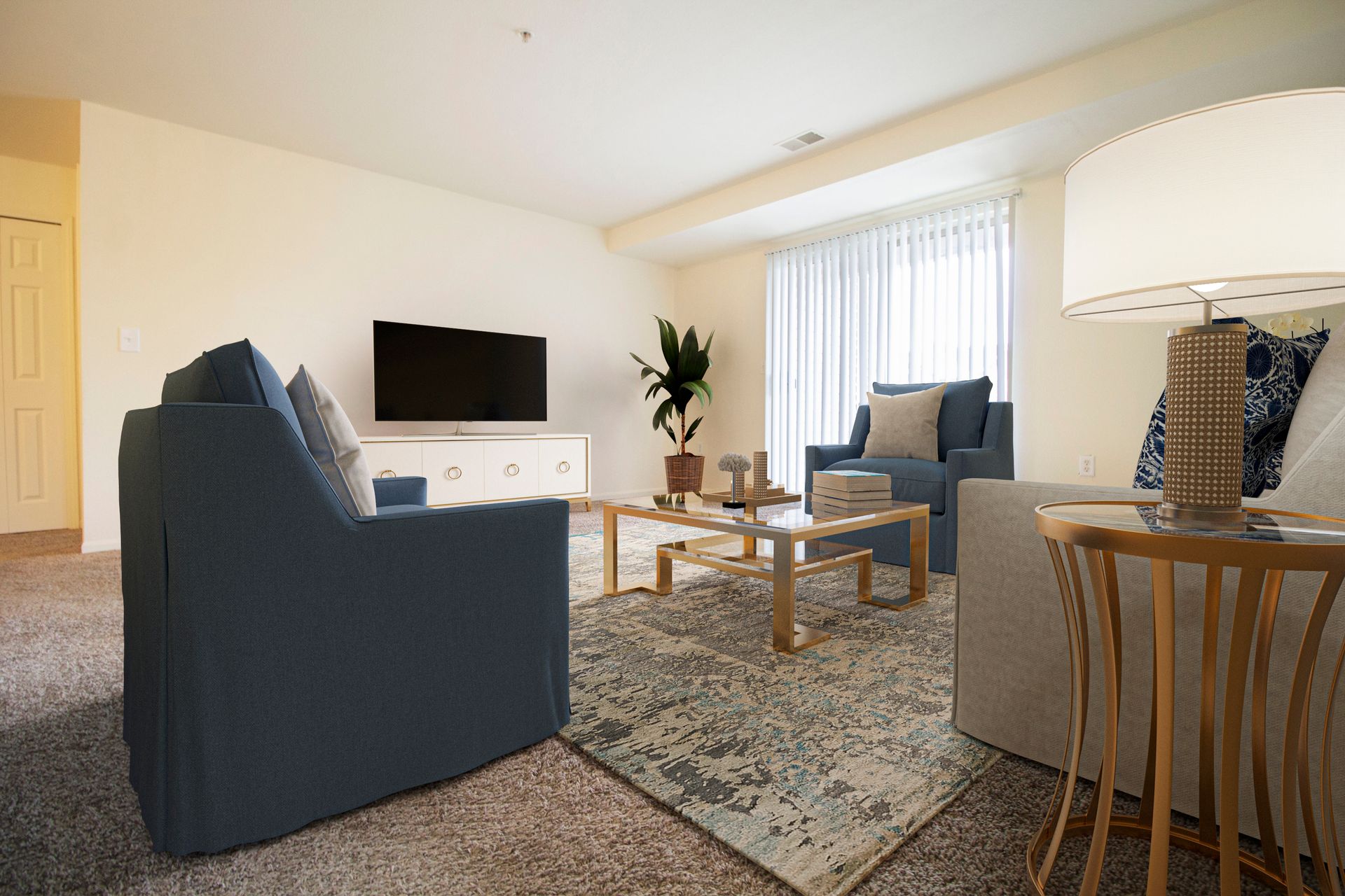 A living room with a couch , chair , coffee table and television.