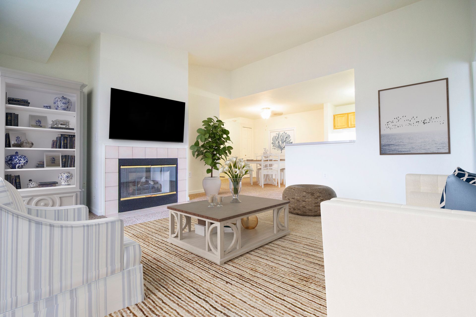 A living room with a fireplace and a flat screen tv