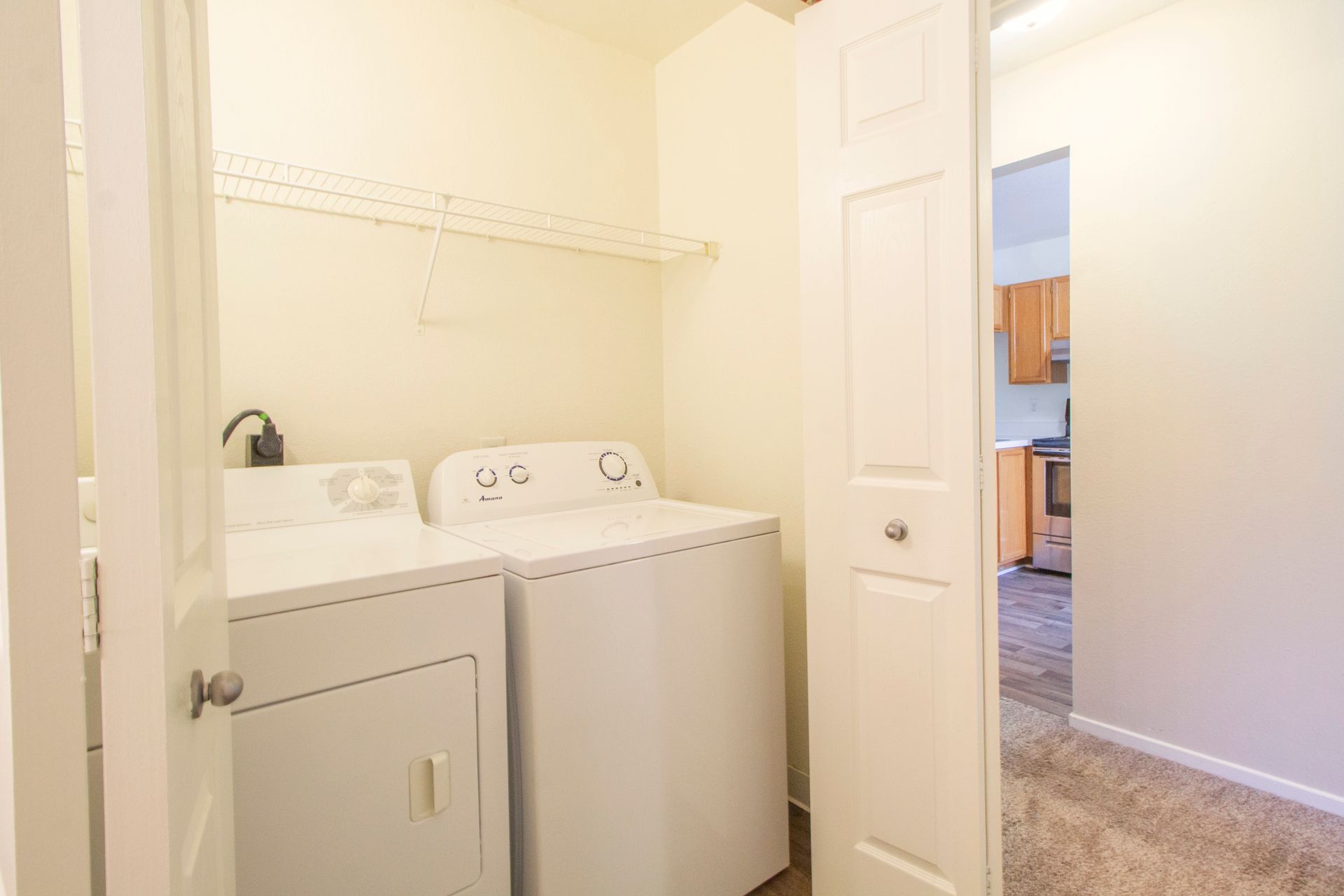 A laundry room with a washer and dryer in a house.
