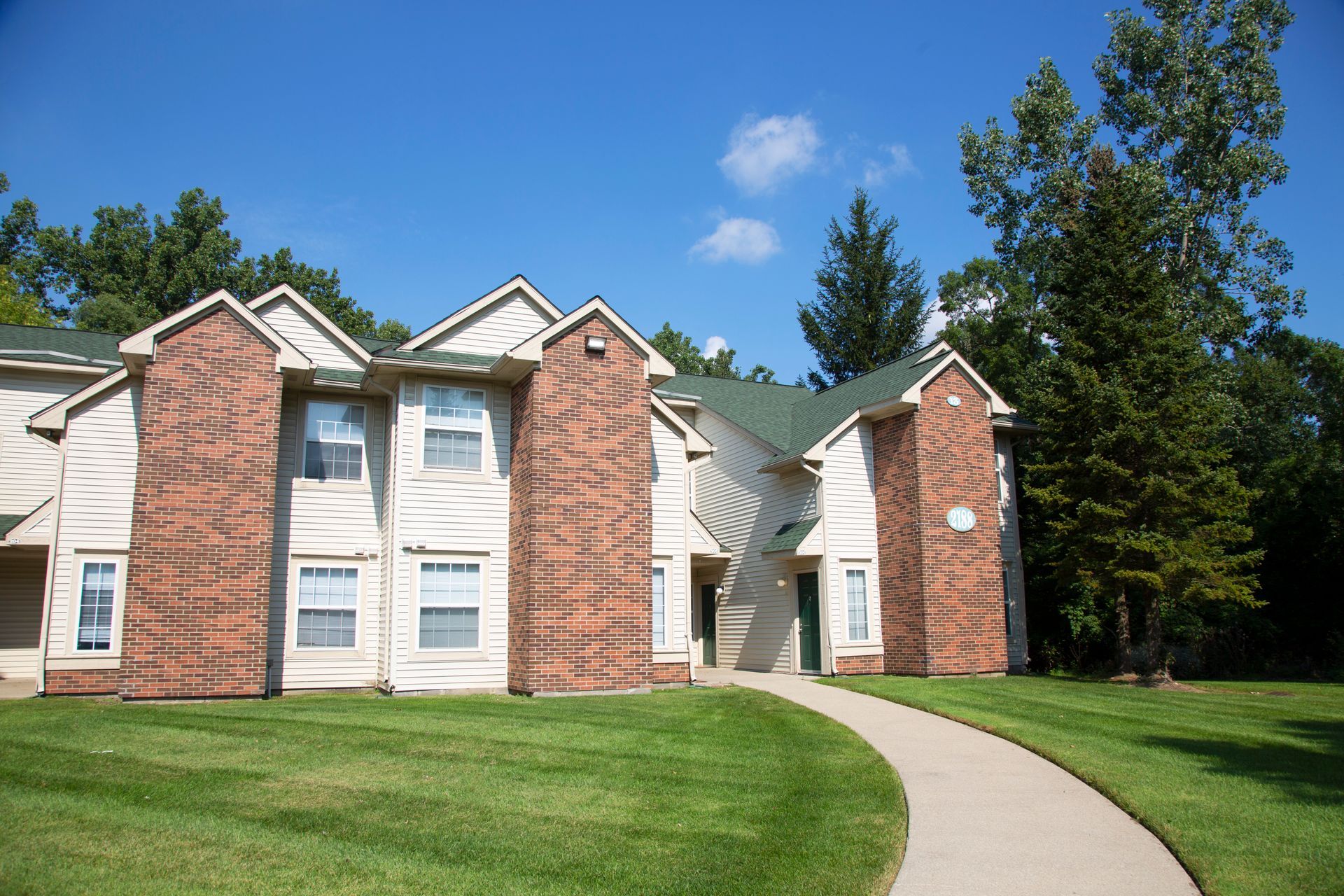 A large brick house with a walkway leading to it