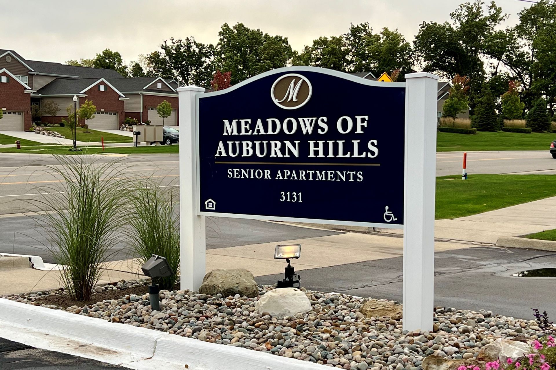 A sign for the meadows of auburn hills senior apartments