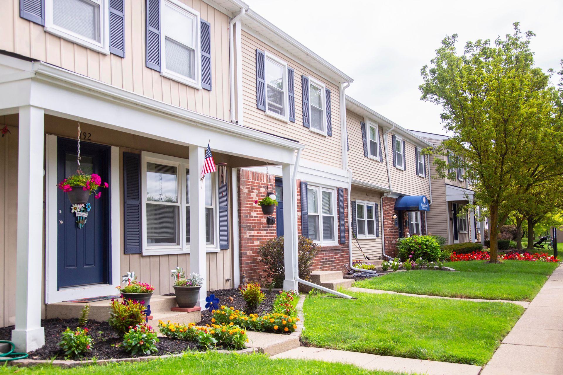 A row of houses with a lush green lawn in front of them.