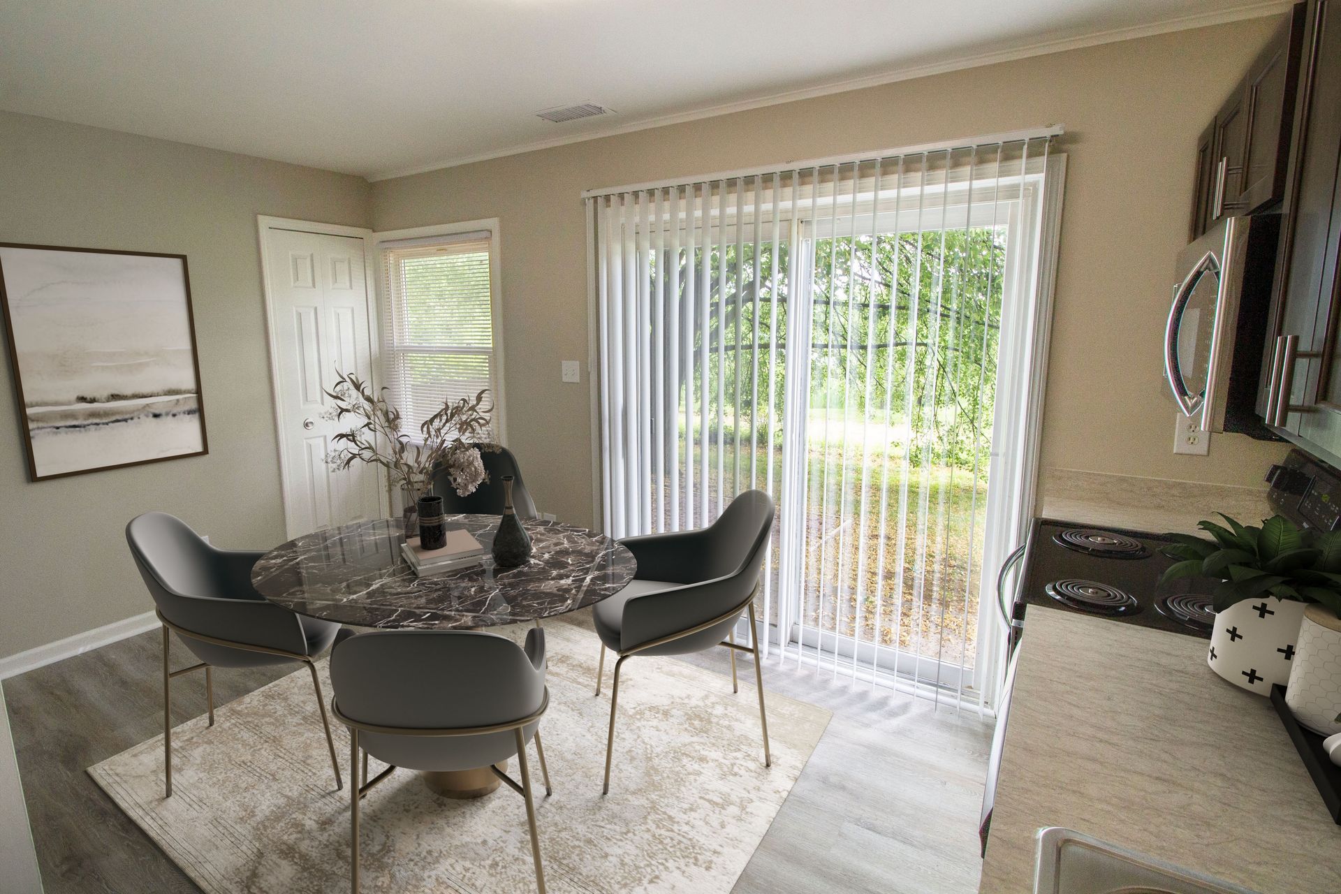 A dining room with a table and chairs and a sliding glass door.