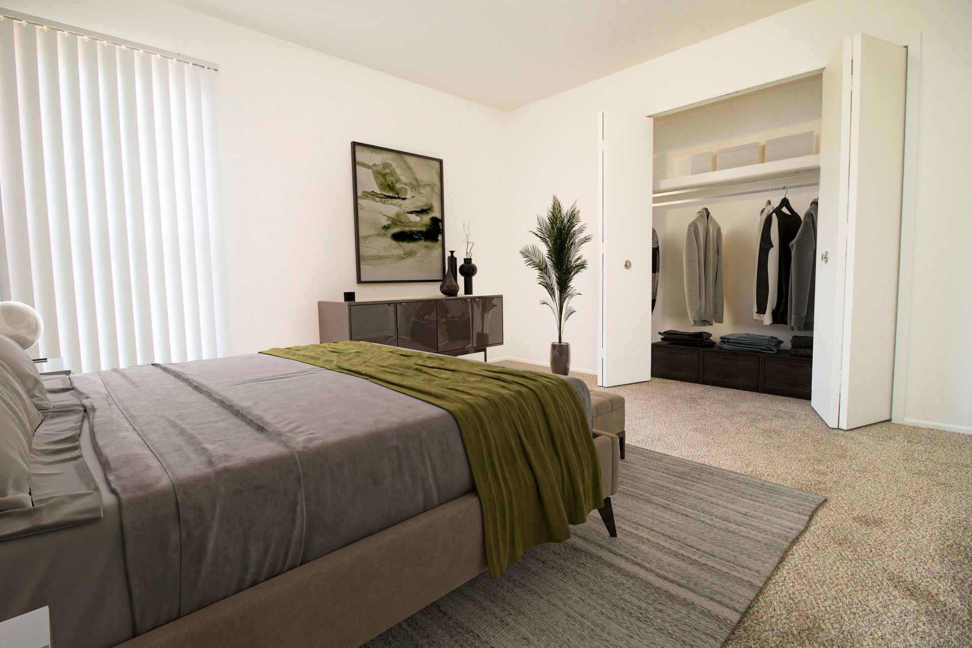 A bedroom with a large bed and a walk in closet.